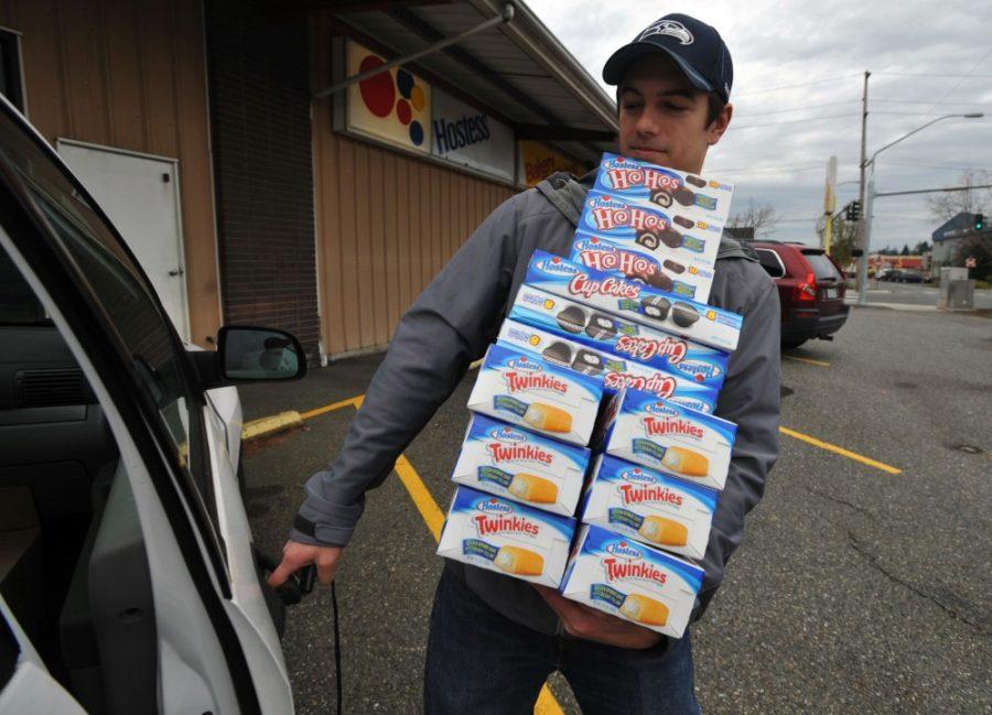Andy Wagar loads Twinkies, Ho-Hos and cupcakes into a van outside the Wonder Bakery Thrift Shop in Bellingham, Washington, on Friday, November 16, 2012, after Hostess filed a motion to liquidate the company's holdings. (Philip A. Dwyer/Bellingham Herald/MCT)

