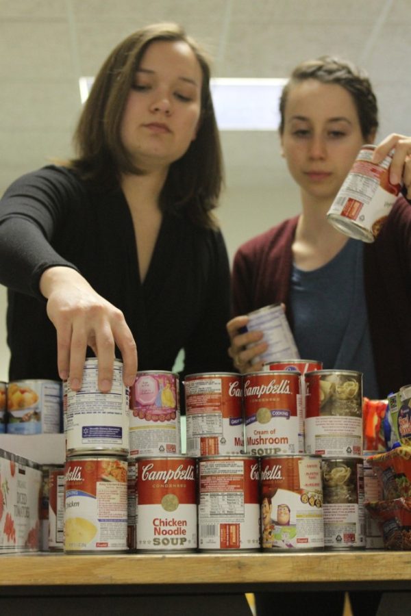 Kelsee Becker /  Arizona Daily Wildcat

Graduate Community Director Michelle Sun and Sophomore Mariel Will, members of The UA Campus Pantry Board, organize donated goods before the Feb. 1 opening. Similar to other campuses across the country, UA Campus Pantry is an emergency food pantry available for those in need within the UA Community.