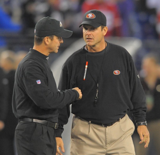 Ravens head coach, John Harbaugh (left) and San Francisco 49ers head coach Jim Harbaugh chat at mid-field prior to their game on Thursday, November 24, 2011, in Baltimore, Maryland. It's the first time in NFL history that two brothers have opposed each other as coaches.  (Doug Kapustin/MCT)