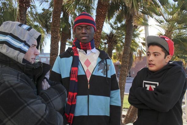Robert Alcaraz / Arizona Daily Wildcat

Freshmen Kyle Jackson, Ayo Odeneye and Julz Jenney huddle in front of Manzanita-Mohave on Monday, Jan. 14, 2013. With Tucson seeing lower temperatures, UA students have been dressing warmer.