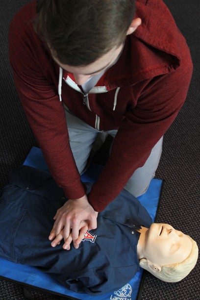 Kelsee Becker /  Arizona Daily Wildcat

Omar Meziab, a second year University of Arizona College of Medicine student, performs the 3 Steps Chest-Compression-Only CPR method on a training dummy. Omar is a member of REACT - a club that trains people how to do the new CPR method. 