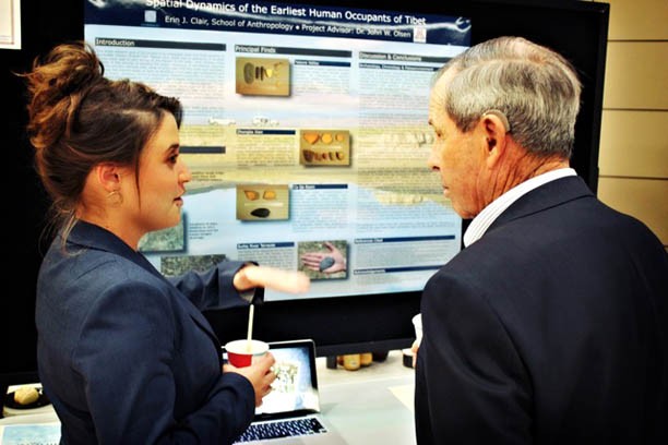	Erin Clair, a former student in the Honors College, shows her research results on early humans in Tibet with former Regent Fred Boice at the Honors Expo in 2012. This year’s expo will take place Wednesday in the Student Union Memorial Center.(Photo courtesy of David Allen, Honors College director of development)