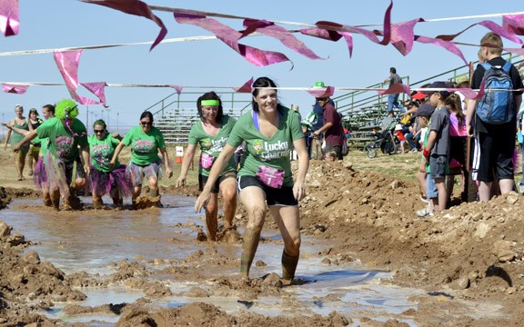 Ryan Revock/ Arizona Daily Wildcat

Participants navigate a muddy obstacle course at the Kiss Me Dirty mud run.  The event was on the Pima County Fairgrounds and the proceeds go to the UA Cancer Center.  