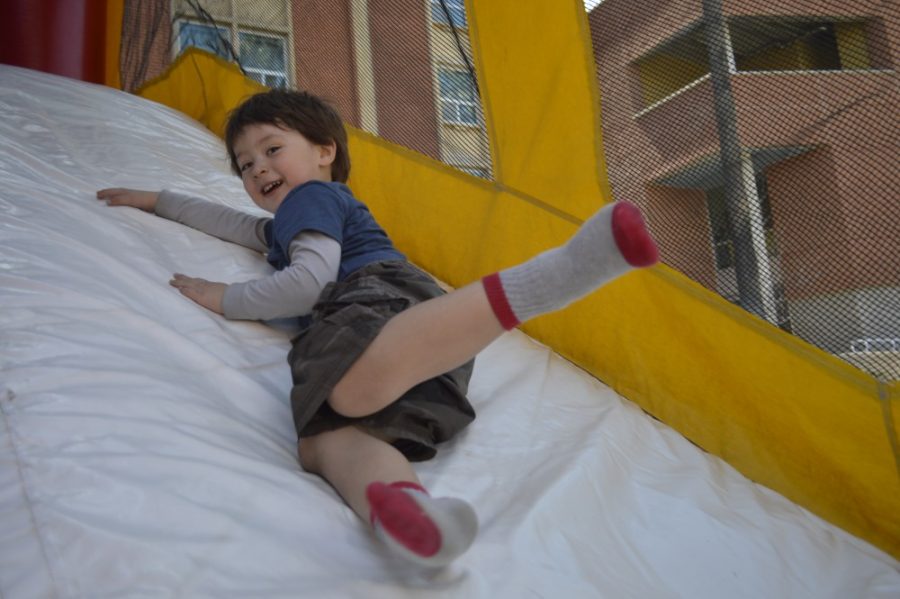Ryan Revock / Arizona Daily Wildcat

Wilson Hilgaertner slides down the slide within the jumping castle at GPSA week Family Fun Day Sunday afternoon.  Family Fun Day was the first ebent for the appreciation week.


