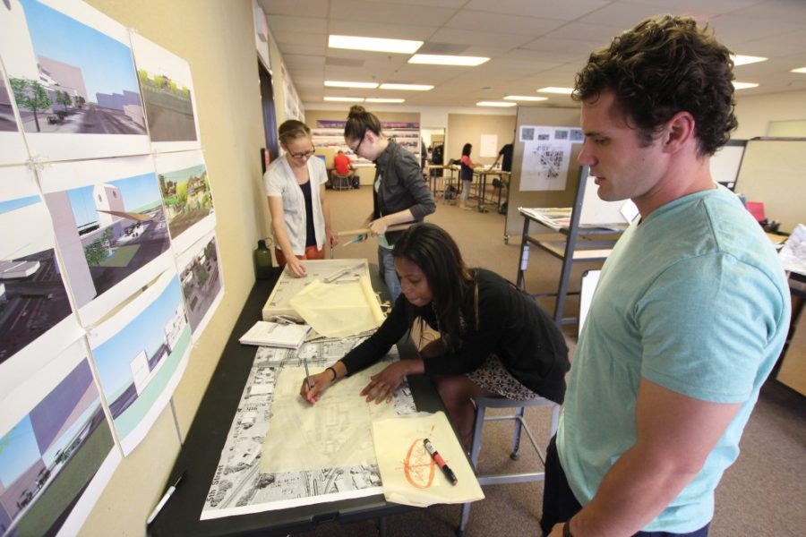 	Kyle Mittan/Arizona Daily Wildcat 

	Erin Besold, a planning graduate student, fourth-year art student Laura Dinardo, fourth-year architecture student Julia Weatherspoon, and Jeff Tarbox, a graduate student studying landscape architecture, go over plans for a project that aims to revitalize Tucson’s warehouse arts district. Students are looking at planning and concepts for downtown development.  