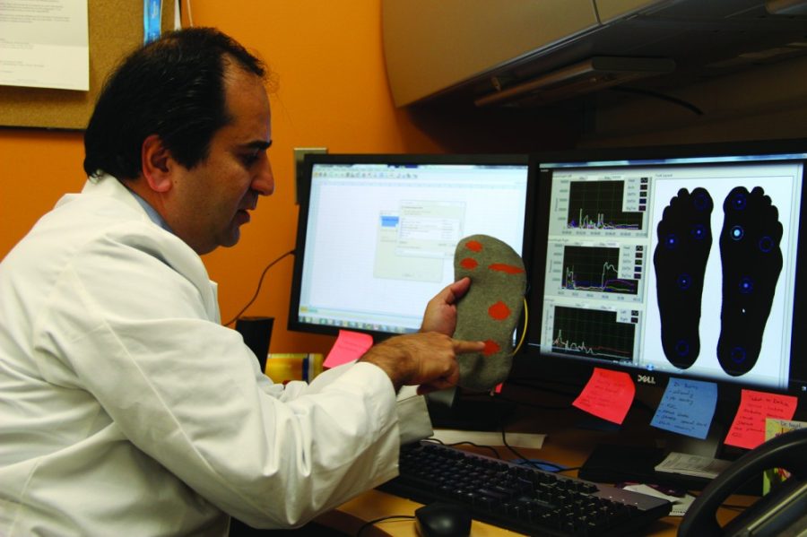 Mark Armao / Arizona Daily Wildcat

Biomedical engineer Bijan Najafi holds a SmartSox prototype. The socks contain fiber-optic threads that can detect the precursors of diabetic foot ulcers.