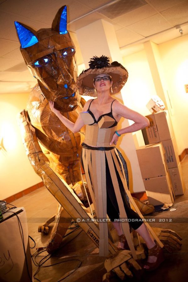 	Photo courtesy of Mykl Wells

	Last year’s Cardboard Ball participant Tammy Allen poses with Mykl Wells’ “Chimera,” a cardboard sculpture.