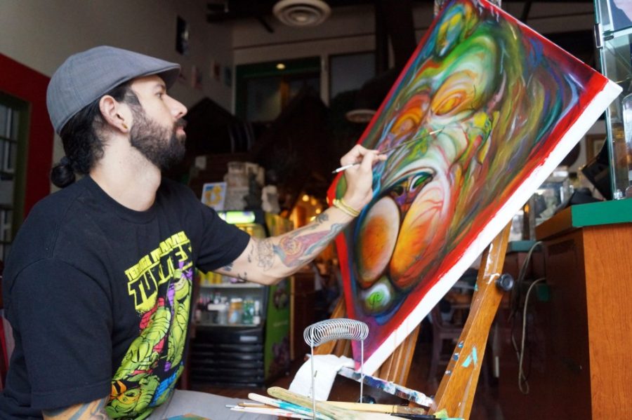 Cole Malham / The Daily Wildcat

Garret Staab painting his newest piece at Espresso Art Cafe on Sunday. 