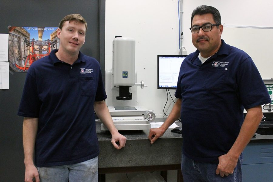 Savannah Douglas / The Daily Wildcat

Larry Acedo (right) and Ryan Willwater (left) work at the University of Arizonas Machining and Welding Center. Behind Acedo and Willwater is the Vision Machine which holds the module base for the NIRCam. 
