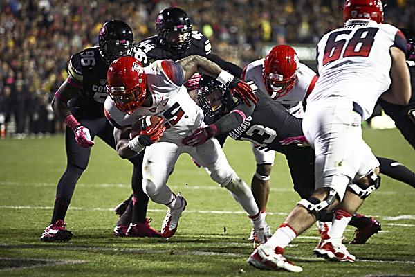 KaDeem Carey (25) runs over the goal line for one of his four touchdowns as Parker Orms (13) of tries to bring him down during a game between Colorado and Arizona at Folsom Field, Saturday, Oct. 26, 2013. (Kai Casey/CU Independent)