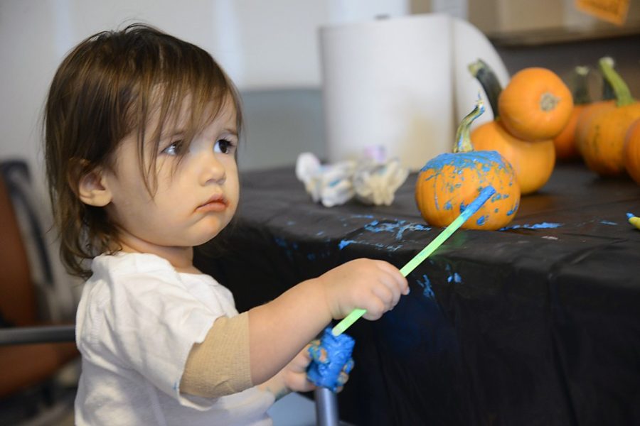 Ryan Revock / The Daily Wildcat

Emma McCormick, who is 20 months old, paints a pumpkin at the 