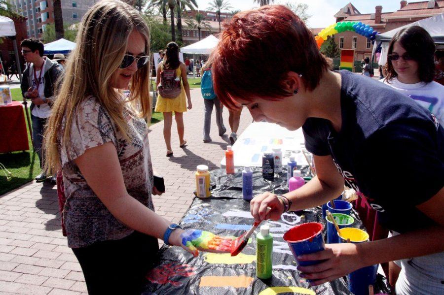  Michaela Kane/ The Daily Wildcat

Katrina Permanson, a freshman studying gender and womens studies, paints senior Lauren Ramseys hand for the kick off of Coming Out Week on Monday. Permanson, an intern with the Pride Alliance, is one of the many volunteers helping at the resource fair. 