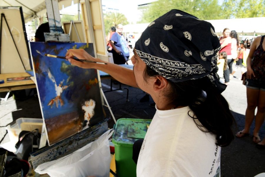 Ryan Revock/ The Daily Wildcat

Artist, Marcelino Clemente Flore III works on an unnamed oil painting on Saturday at the Tucson Meet Yourself Festival.  