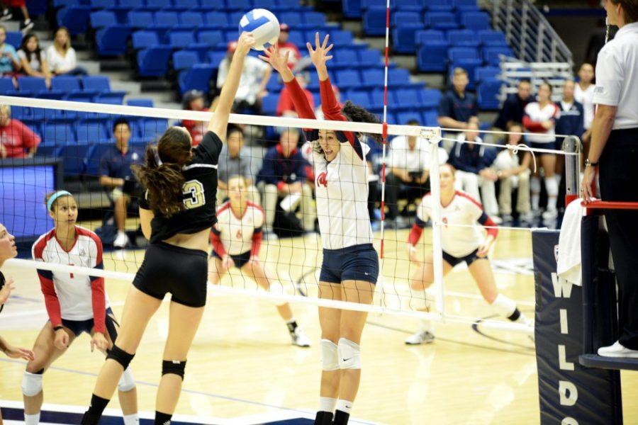 Ryan Revock / The Daily Wildcat

Junior Outside Hitter Taylor Arizobal jumps to block a spike from a Wofford player on Sept. 21 at the McKale Memorial Center.