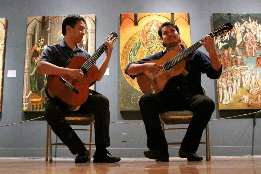 Rebecca Marie Sasnett / The Daily Wildcat

Ivar-Nicholas Fojas (left), third year doctor of musical arts, and Misael Barraza Diaz (right), second year masters degree in guitar performance, practices their guitar duo in the University of Arizona Museum of Art Thursday, Nov. 7, 2013. 
