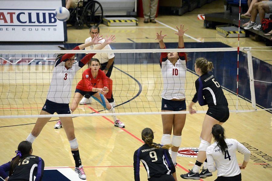 Ryan Revock/ The Daily Wildcat

Washington junior outside hitter Kaleigh Nelson spikes the ball which gets by UAs Halli Amaro (left) and Jane Croson (right) at the McKale Memorial Center on Sunday.  
