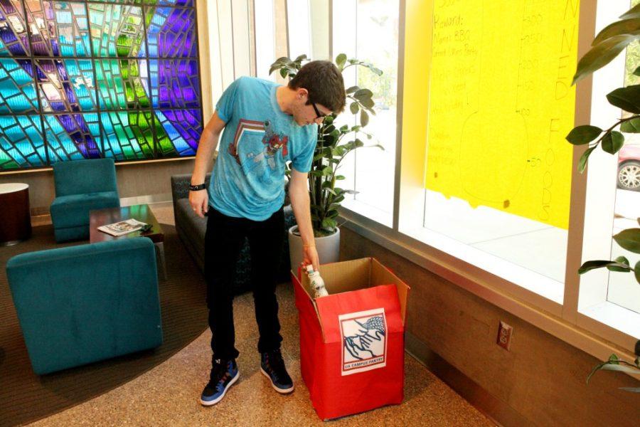 Shane Bekian / The Daily Wildcat

Stephen Hall, a Library Sciences graduate student, donates an item to the Haiyan Food Drive at Likins Residence Hall on Nov. 16. All food items go to victims of the typhoon disaster in the Philippines. 
