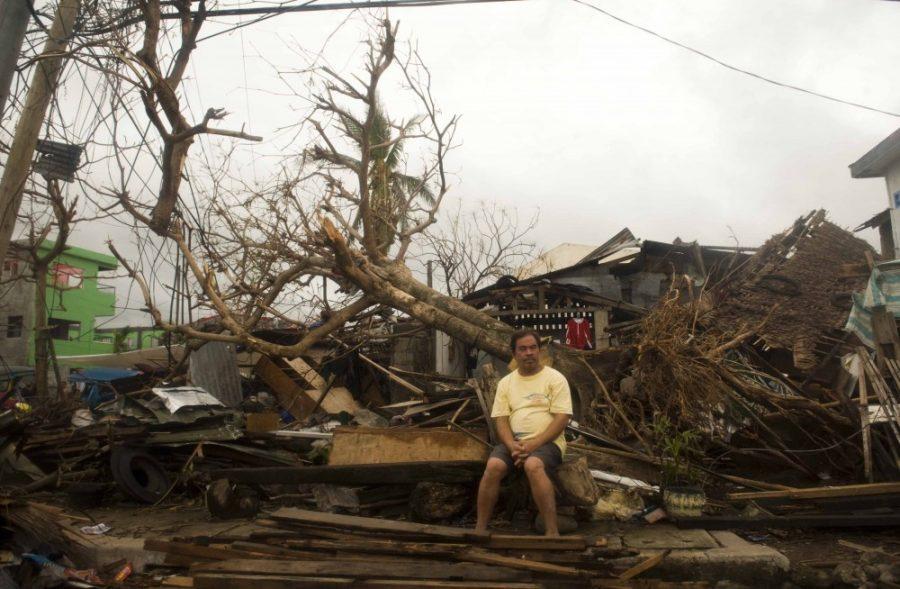 A resident sits on debris in typhoon-hit Leyte Province, Nov. 12, 2013. The United Nations said it had released $25 million in emergency funds to pay for emergency shelter materials and household items, and for assistance with the provision of emergency health services, safe water supplies and sanitation facilities. Its launching an appeal for more aid. (Lui Siu Wai/Xinhua/Zuma Press/MCT)