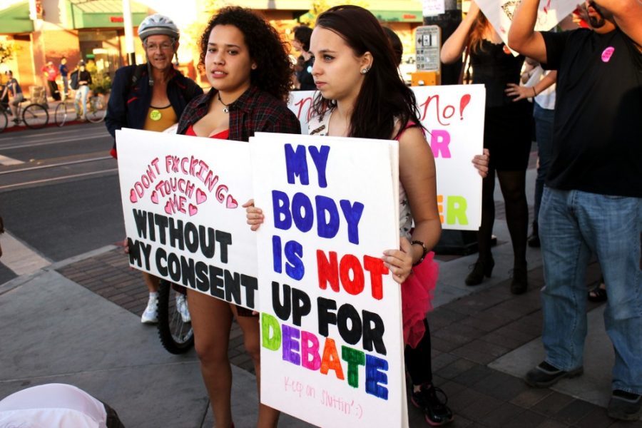 Savannah Douglas / The Daily Wildcat

Karlie Fields (right) and Claudia Ortega (left), both Tucson citizens, participate in the Tucson SlutWalk on Saturday. The girls hold signs advocating for the cause. 