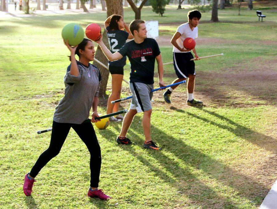 Rebecca Marie Sasnett / The Daily Wildcat

Emily Rodela, graduate,Tyler Murphy, junior, and Mark Stethem, sophomore,  practice beater drills during quidditch practice at Himmel Park, Friday, Nov. 15, 2013. The Quidditch Tournament is this weekend in Mesa, Ariz.