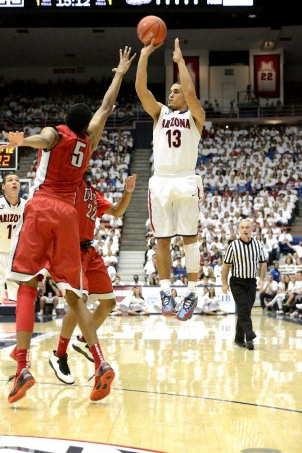 Ryan Revock/ The Daily Wildcat

UA junior guard Nick Johnson shoots a three-pointer against UNLV on Saturday in the McKale Center. 