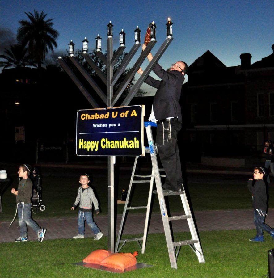 Lili Steffen/ The Daily Wildcat

Chabad at the UA held a menorah lighting ceremony celebrating Chanukah with latkes and doughnuts for UA students away from home on the UA Mall, Tuesday. Rabbi Yossi Winner gave an opening address and led the prayers for Chanukah.