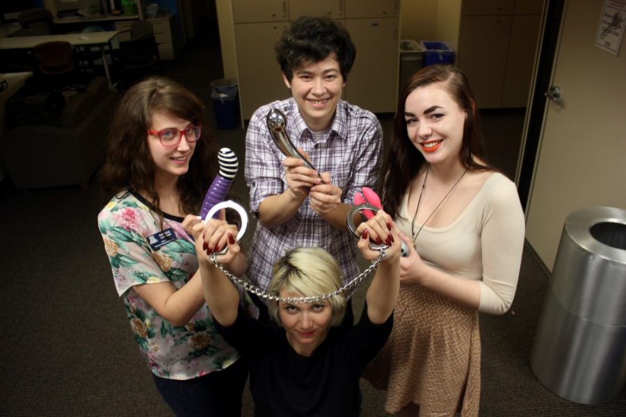 Savannah Douglas/  The Daily Wildcat

Marisa Calegari (left), Mathew Bugaert (center), Claire Larkin (right), and Brianne Grossenburg (bottom center) show off sex toys that were discussed at the Womens Resource Center during Tuesdays censored series. Students who attended were shown a large variety of toys and educated on how to safely use them. 