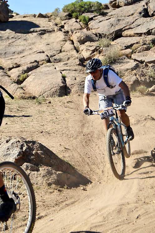 Daniela Vizcarra / The Daily Wildcat 

Antonio Espinosa rides down the infamous rock in the last leg of the 24 Hours in the Old Pueblo mountain bike race in Oracle, Ariz., on Saturday. Espinosa was apart of a 5-man team and rode two laps in the 18-mile mountain bike trail. 