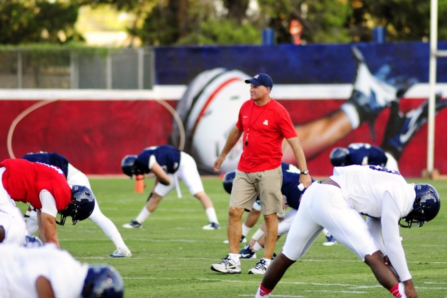 %09Arizona+football+head+coach+Rich+Rodriguez+walks+through+the+Wildcats%26%238217%3B+stretching+formation+during+a+practice.+Arizona+begins+spring+football+practices+Monday%2C+and+with+them+the+process+of+determining+a+new+starting+quarterback+and+a+new+No.1+running+back.