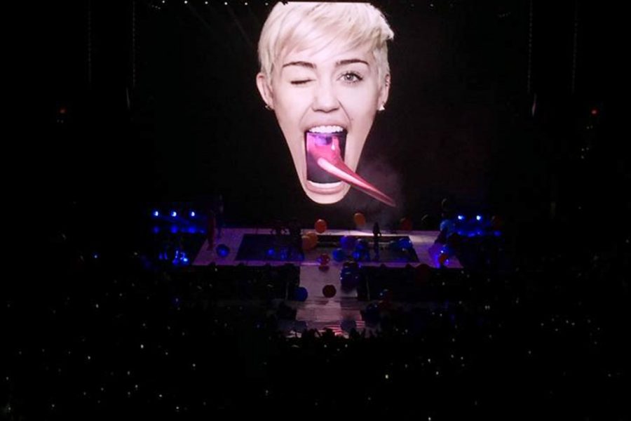 	Courtesy of Allison Field

	Miley Cyrus enters the stage via a tongue slide protruding from a giant image of her own face. Cyrus’s concert took place last Thursday in Phoenix. 