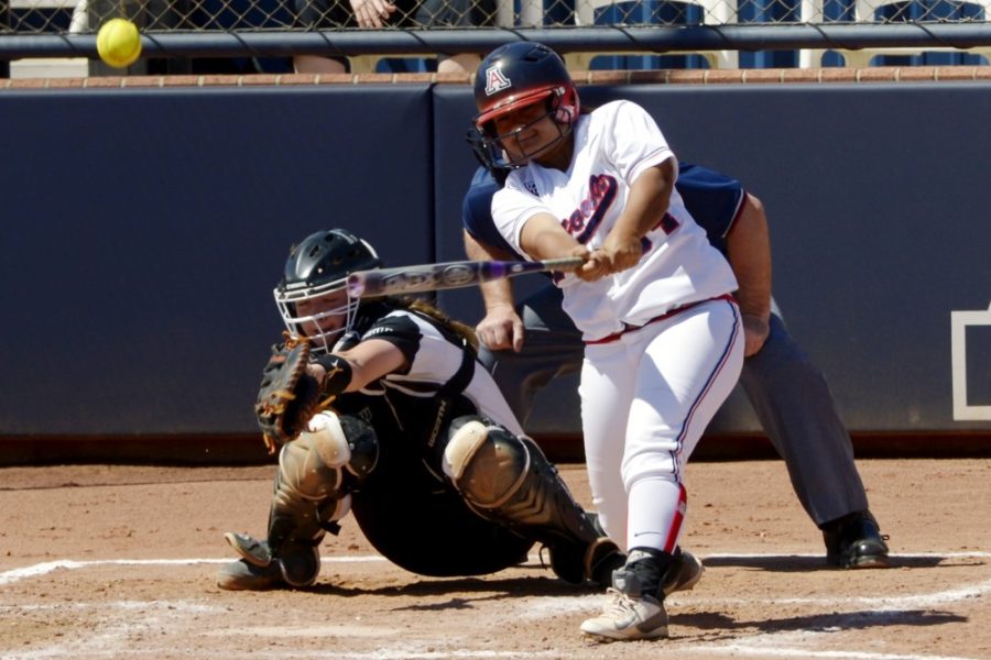Carlos Herrera / The Daily Wildcat

Freshman infielder Katiyana Mauga hits the ball to bring junior catcher Chelsea Goodacre to home plate during Arizona's 14-1 win against Oregon State on March 24 at Hillenbrand Memorial Stadium.