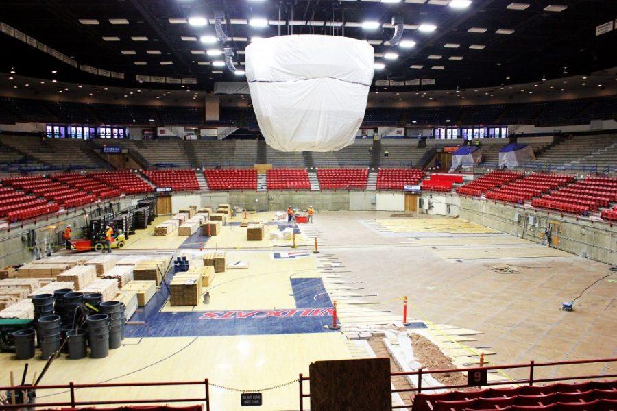 	Construction workers remove the floor of McKale Memorial Center during the McKale renovation project on Tuesday afternoon. The McKale renovation project is set to conclude by the start of the 2014 fall semester and will include a new court, new locker rooms, new score board and new seats. 
