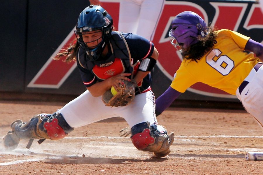 	Arizona junior catcher Chelsea Goodacre (77) tries to tag out LSU junior outfielder A.J. Andrews (6) at home plate during the 6th inning of Arizona’s 5-1 loss against LSU in game six of the NCAA Tucson Regional at Hillenbrand Stadium on Sunday afternoon. The seventh game of the Tucson Regional saw Arizona defeat LSU 13-5 in five innings to advance to the NCAA Super Regionals.  