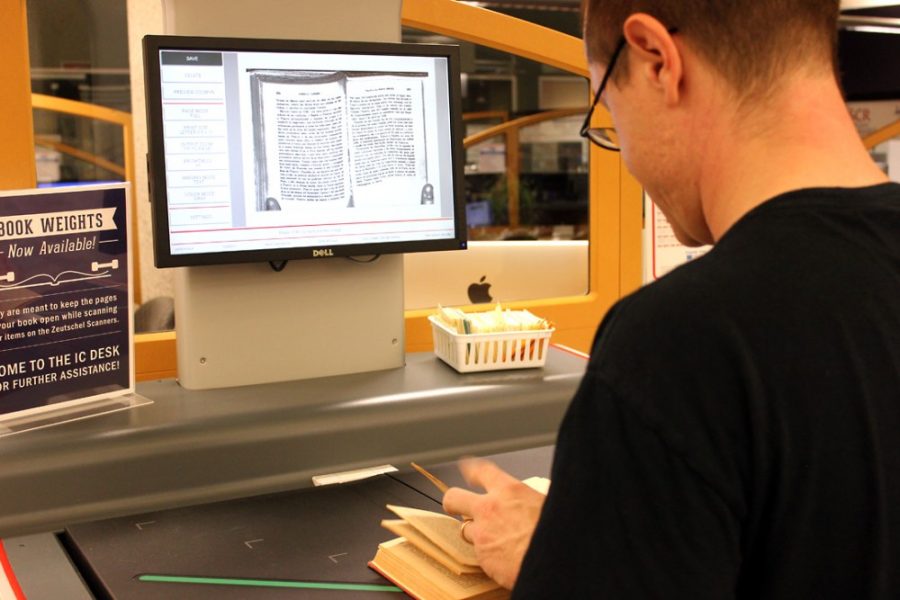Savannah Douglas  / Arizona Summer Wildcat

Matt Furlong, a doctoral candidate for the history of Latin America, scans pages of Viaje a la Nueve Espana for research for his dissertation on Tuesday. The overhead scanner is located on the bottom floor of the Main Library. 

