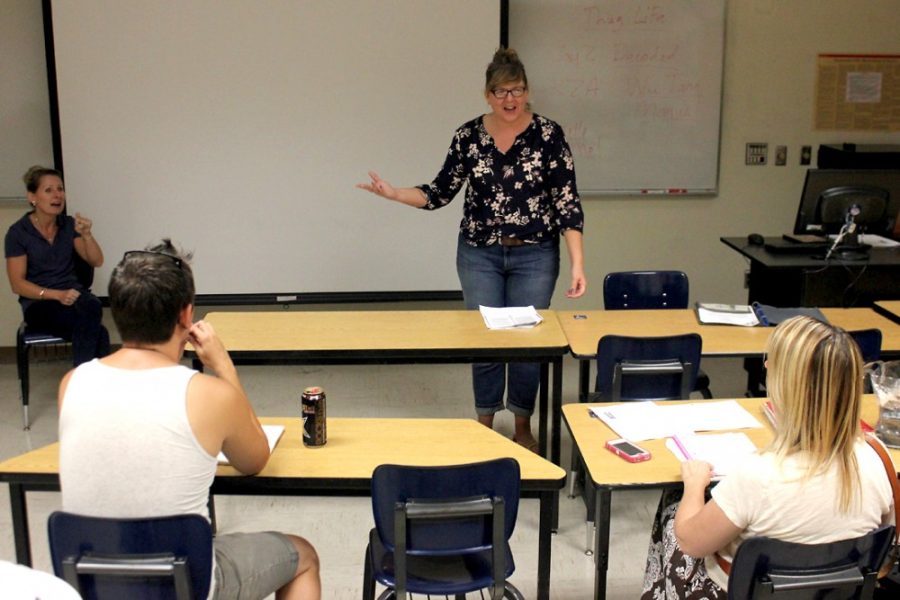 	April Bond, a graduate student in American Indian Studies, reviews an article with her summer class, American Indians in Film, on Tuesday in the Harvill building. AIS is now a department within the College of Social and Behavioral Sciences.