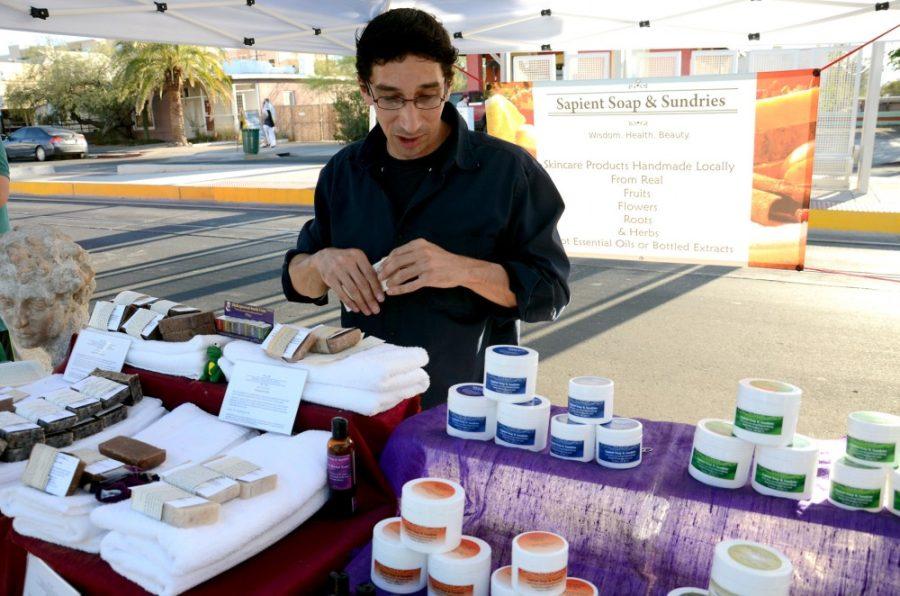 Rebecca Noble  / Arizona Summer Wildcat

Leighton Jeffy, co-founder of Sapient Soap and Sundries sets up his herbal merchandize at the farmers market on the corner of 4th Ave. and 4th St. on Friday, June 27th. Jeffy and his wife wrap their bars of soap in pages of books the couple finds literary significance in.