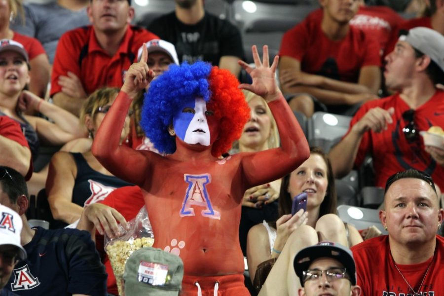 A+UA+fan+supports+the+Wildcats+with+a+hand+gesture+and+paint+during+Arizonas+season+opener+against+UNLV+at+Arizona+Stadium+on+Friday%2C+Aug.+29%2C+2014.+Arizona+won+58-13+against+UNLV.+Anu+Solomon+broke+the+freshman+passing+yards+record+with+425+yards.+%0APhoto+taken+on+Monday%2C+Aug.+29%2C+2014.+Photo+by%3A+Rebecca+Marie+Sasnett+%2F+The+Daily+Wildcat