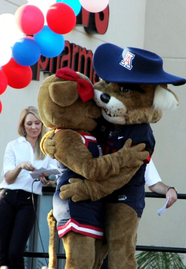 Wilbur hugs Wilma after saving her from a cowboy in a skit during Bear Down Friday on University Boulevard on Thursday, Aug. 28,
2014.