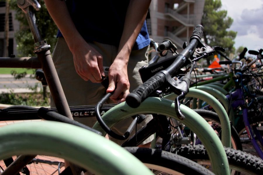 Rebecca Marie Sasnett / The Daily Wildcat

Material Science and Engineering junior Ryan OConnell locks up his bike in front of the Park Student Union on Tuesday, Aug. 26, 2014, in Tucson, Arizona. 