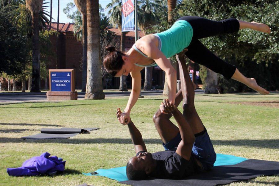 Rebecca Marie Sasnett / The Daily Wildcat

Ali Buckmore, 3rd year studing neuroscience, and Emily Guindon, fitness trainer, practice acroyoga on the University of Arizona campus, Sunday, Dec. 1, 2013. Acroyoga, or acrobatic yoga, is a practice routine that uses techniques from yoga and acrobatics