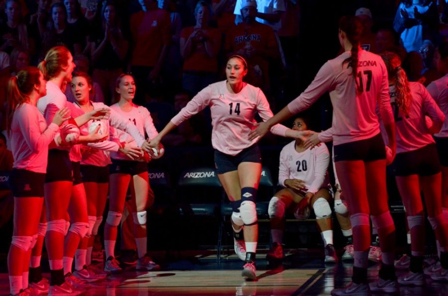 <p>Arizona senior outside hitter Taylor Arizobal (14) walks onto the court during player introductions before Arizona's 3-1 loss against Washington in McKale Center on Sunday. Arizobal and the Wildcats head to the Oregon schools this week.</p>