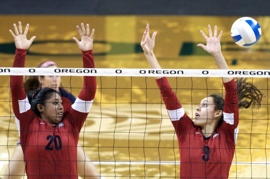 <p>Courtesy of Taylor Wilder / Daily Emerald</p><p>Arizona sophomore setter Penina Snuka (20) and Arizona junior middle blocker Halli Amaro (3) try to block a spike by Oregon during Arizona' s 3-0 loss against Oregon at the Matthew Knight Arena in Eugene, Ore., on Wednesday. The Wildcats lost in straight sets to the Ducks.</p>
