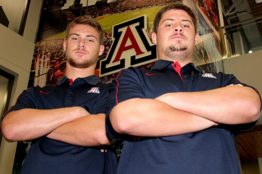 Arizona football freshman tight end Trevor Wood (left), 88, and redshirt junior offensive lineman Carter Wood (right), 66, are brothers and followed in their family footsteps by attending Arizona. Trevor and Carter Woods father, David Wood, and uncle, Brent Wood, played for the Arizona football team during the 1980s, and their mother, Jan Wood, met their father while attending the UA.
