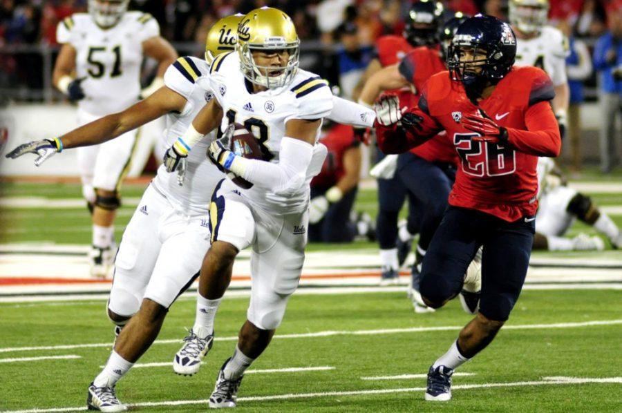 Arizona+football+then-sophomore+safety+Anthony+Lopez+%2828%29+pursues+UCLA+football+then-freshman+receiver+Thomas+Duarte+%2818%29+during+Arizonas+31-26+loss+against+UCLA+at+Arizona+Stadium+last+season.+The+Bruins+and+Wildcats+are+among+a+handful+of+Pac-12+South+teams+who+will+face+each+other+this+week.
