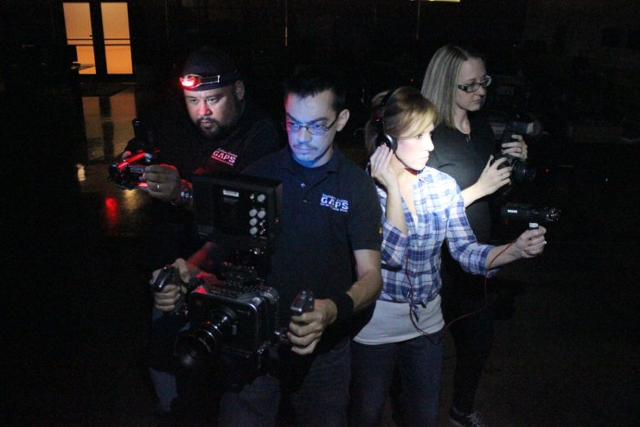 Rebecca Marie Sasnett /  The Daily Wildcat

Nicole Amy (black shirt), historical investigator, Hector Barragan (black shirt with headlight), Investigative coordinator, Jim Rundel (big camera), Tech manager, and Laura Ziegler (flashlight), case manager, make up Southern Arizona Ghost and Paranormal Society, also known as G.A.P.S.