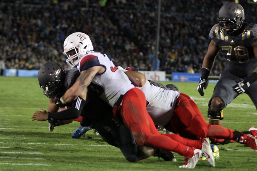 Arizona+linebacker+Scooby+Wright+%2833%29+tackles+UCLA+quarterback+Brett+Hundley+%2817%29+just+short+of+the+endzone+in+the+second+quarter+of+Arizonas+17-7+loss+to+UCLA+at+the+Rose+Bowl+in+Pasadena%2C+Calif.%2C+on+Saturday.+Wright+has+emerged+as+the+leader+of+Arizonas+defense+during+his+sophomore+season.