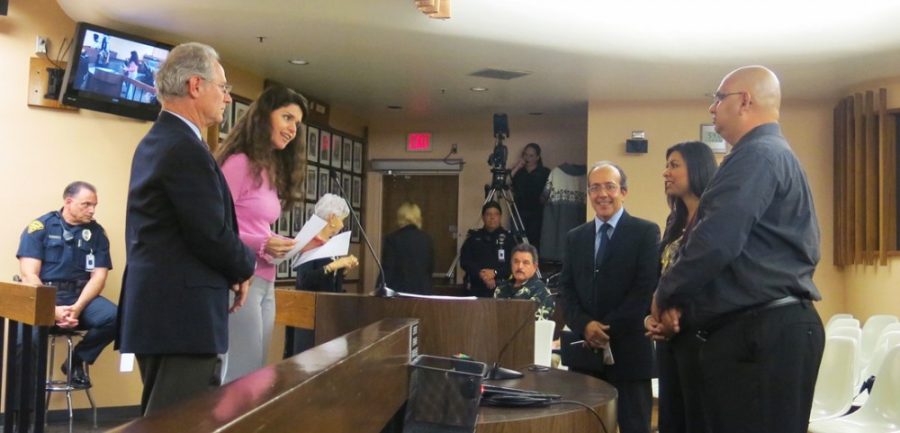 Courtesy of UA NewsJaime Fatás, left, Lizbeth Feria, center, and Leonardo Vega, right, are recognized by Tucson Mayor Jonathan Rothschild during a monthly meeting at City Hall on Nov. 5. The three UA affiliates are working to create more campuswide translating projects.