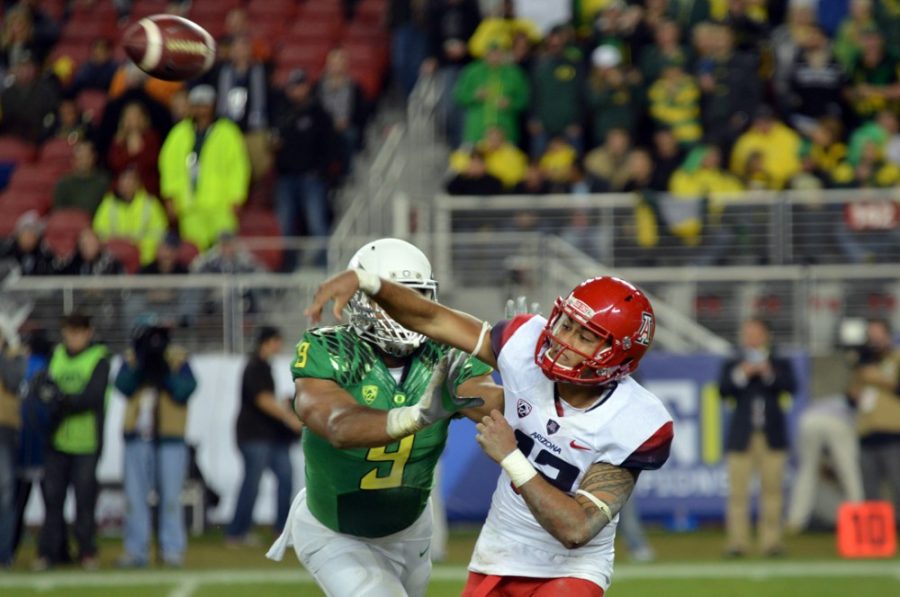 <p></p><p>Arizona quarterback Anu Solomon (12) throws just before being tackled by Oregon defensive lineman Arik Armstead (9) during Arizona's 51-13 loss to Oregon at Levi's Stadium in Santa Clara, Calif., on Friday. The Wildcats went through three different quarterbacks against the Ducks, creating positional confusion for the VIZIO Fiesta Bowl.</p>
