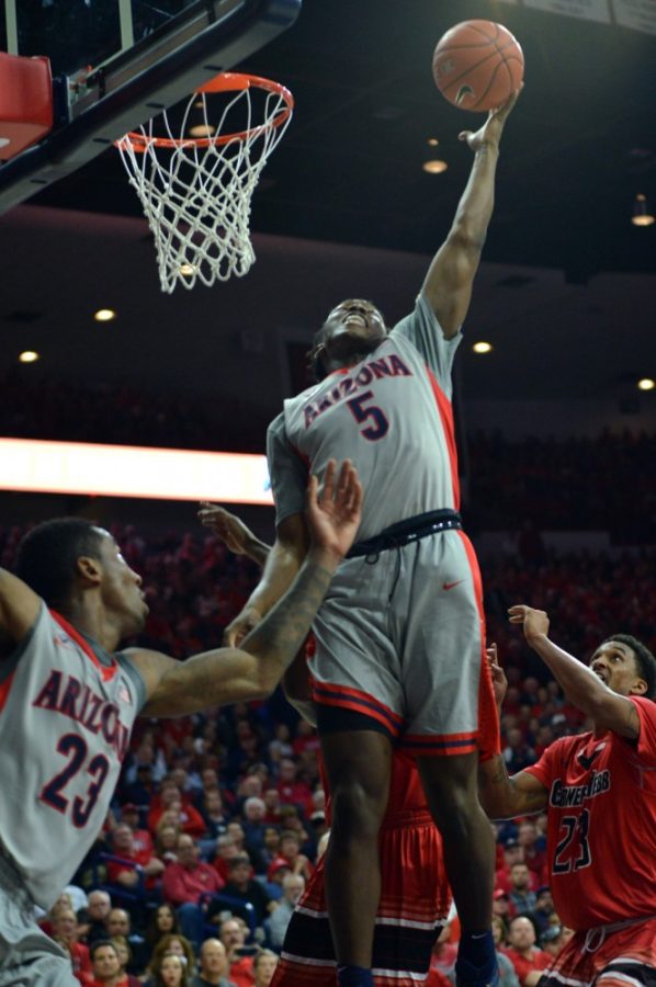 Arizona mens basketball forward Stanley Johnson (5) goes up for a rebound during Arizonas 91-65 win against Gardner-Webb on Tuesday in McKale Center. Johnson has stepped up his game over the past four games after head coach Sean Miller called out the freshman for a lack of energy.