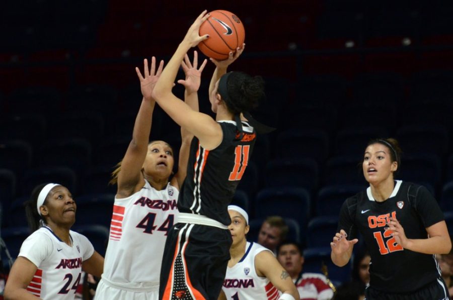 Arizona womens basketball guard Charise Holloway (44) tries to block  Oregon State guard Gabriella Hansons (11) shot during Arizonas 73-55  loss to Oregon State in McKale Center on Friday. Holloway, a freshman,  has taken up a leadership role on the Wildcats team this season.